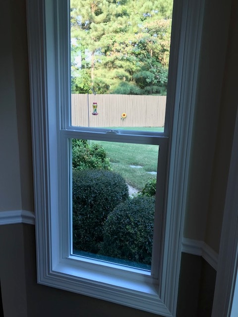 Interior view of newly installed window overlooking backyard