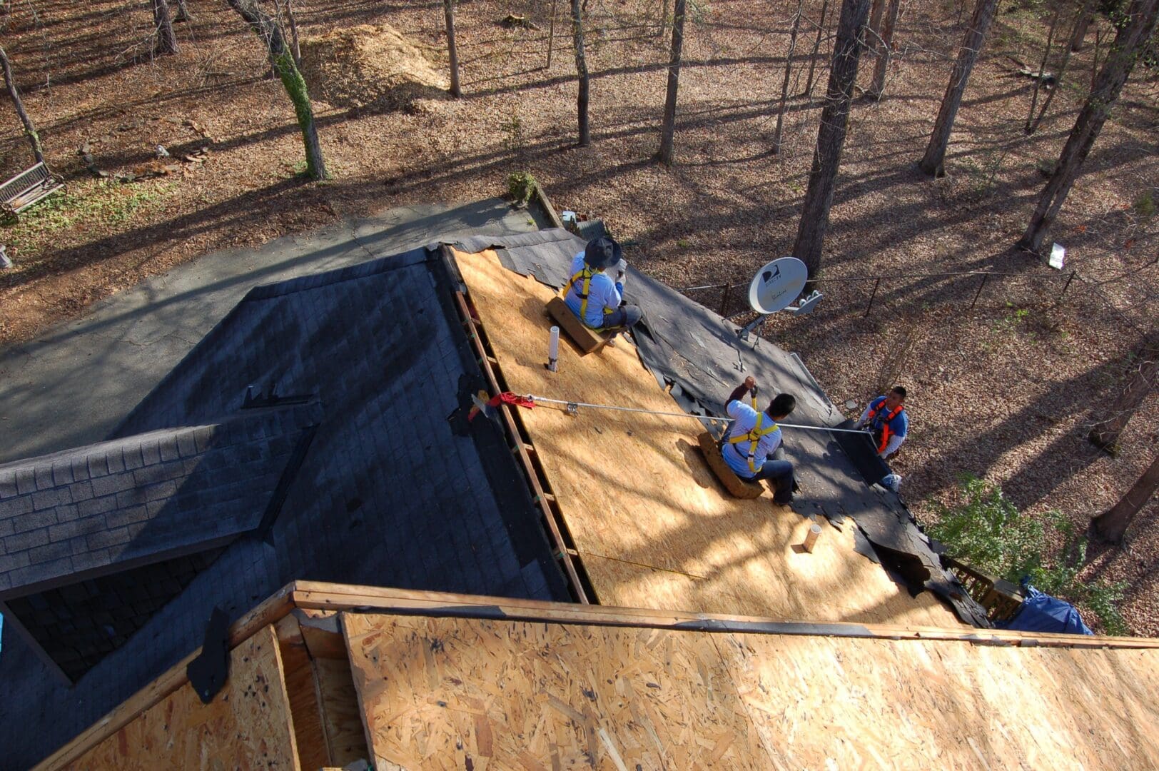 A group of people working on the roof of a building.